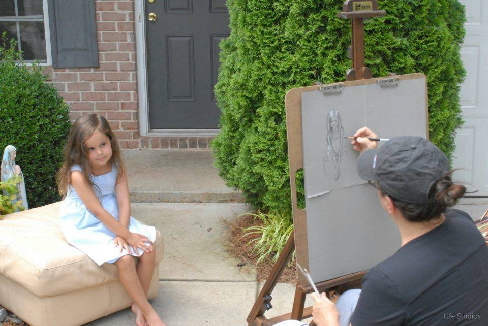 Heather Collins painting at her easel